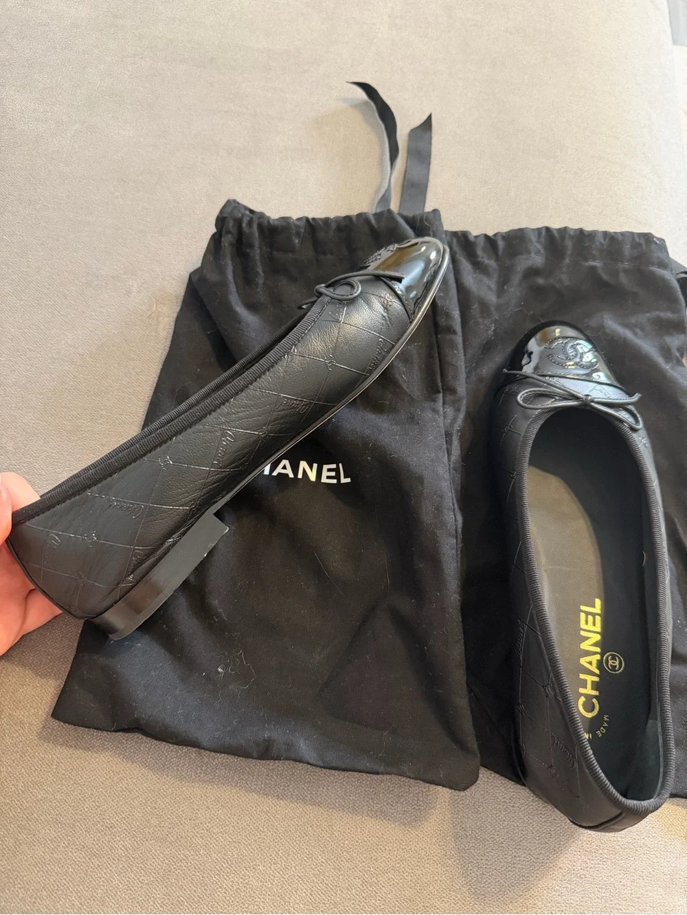CHANEL Black Quilted Leather Cap-Toe Bow Ballet Flats